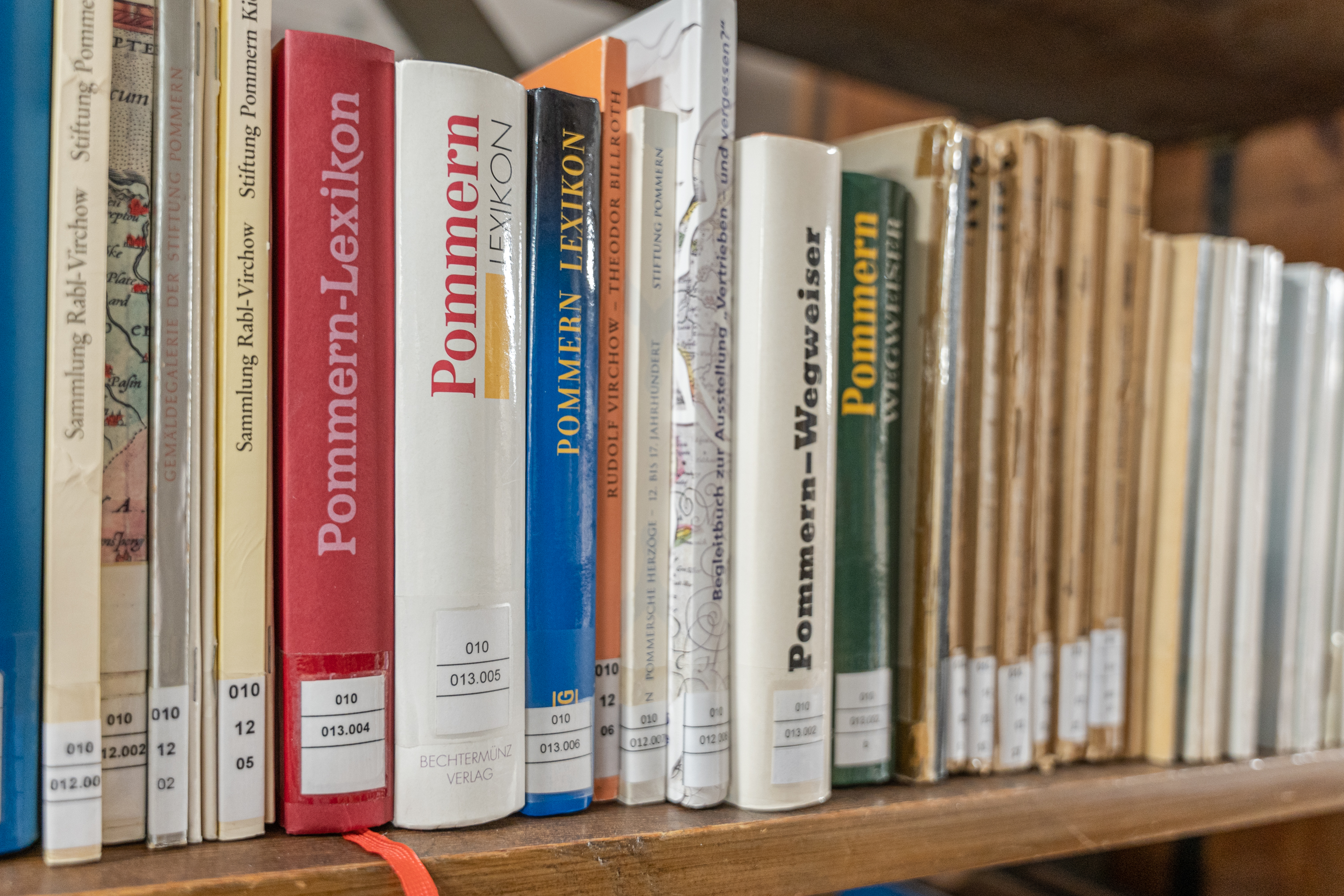 Bücher zu Pommern stehen in einem Regal der Alten Universitätsbibliothek.  